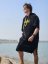 Surf Poncho BejkRoll WAVE MASTER - black - boy on the steps by the water - front
